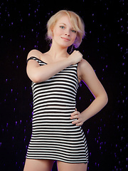 Feeona A posing in her boy-hugging dress before sprawling sensually on the cold, damp floor.