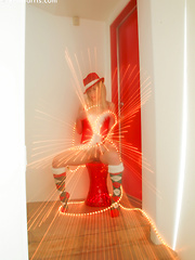 Kara in her sexy christmas outfit wrapped in lights spreading her pussy